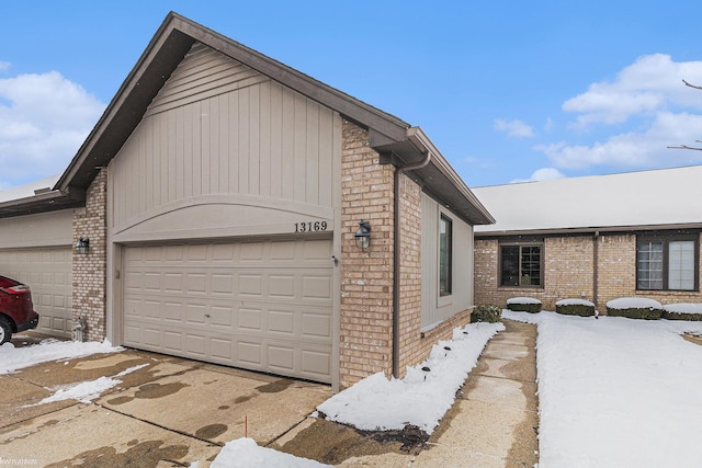 view of snow covered exterior with a garage