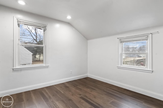 bonus room with vaulted ceiling, a healthy amount of sunlight, and dark hardwood / wood-style flooring