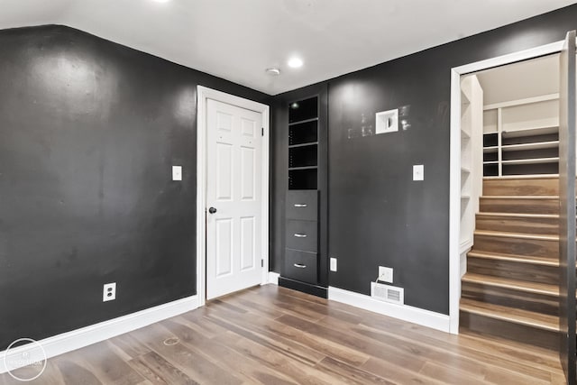 unfurnished room with wood-type flooring