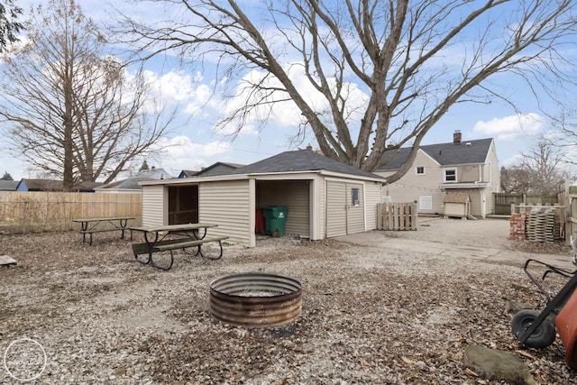 back of property featuring a shed