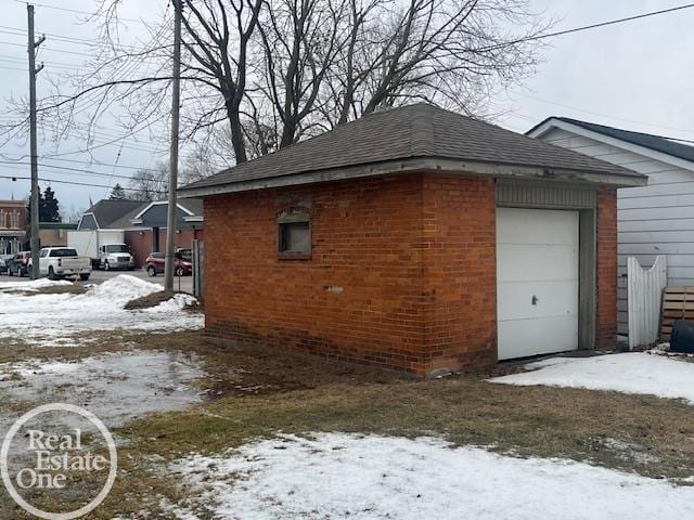 snow covered property featuring a garage