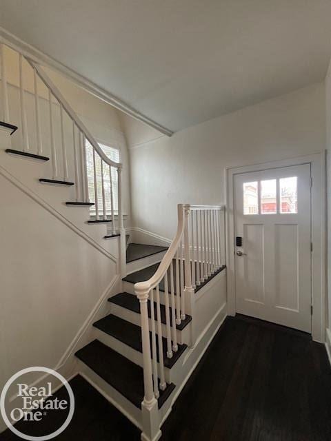 staircase with hardwood / wood-style flooring