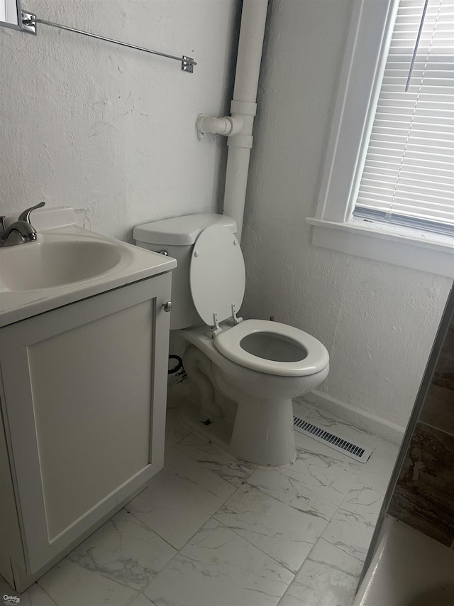 bathroom featuring vanity and toilet