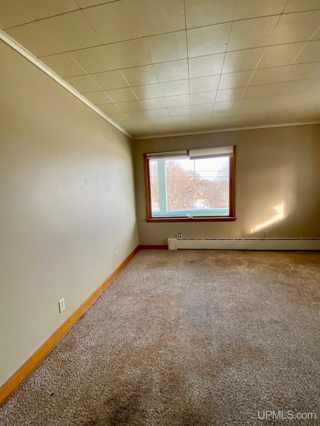 carpeted empty room featuring ornamental molding and baseboard heating