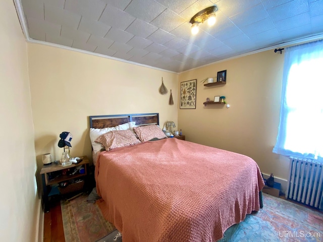 bedroom with radiator and ornamental molding