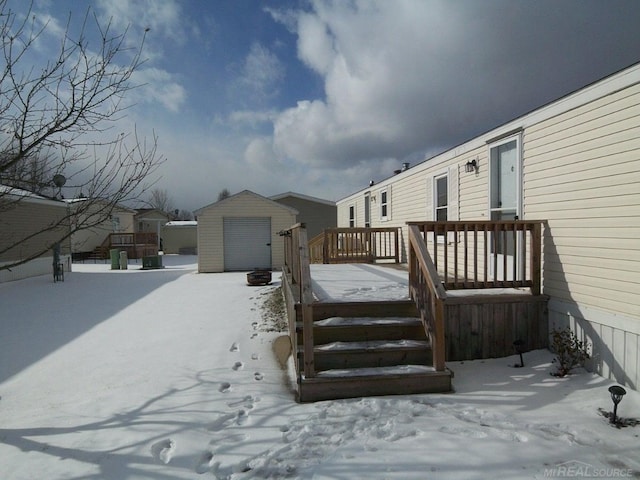 snow covered deck featuring a storage unit