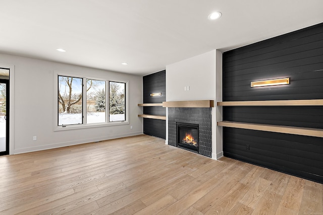 unfurnished living room with light hardwood / wood-style flooring