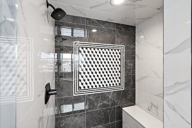 bathroom featuring a tile shower