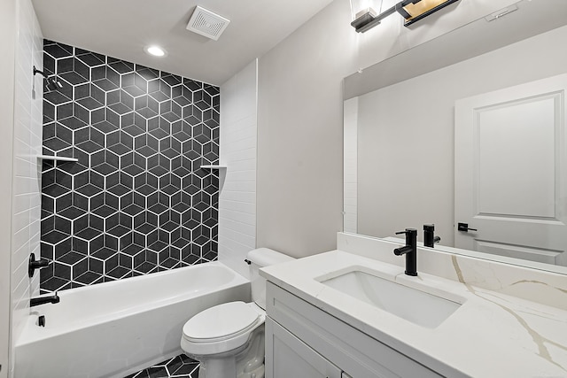 full bathroom featuring tiled shower / bath combo, vanity, and toilet