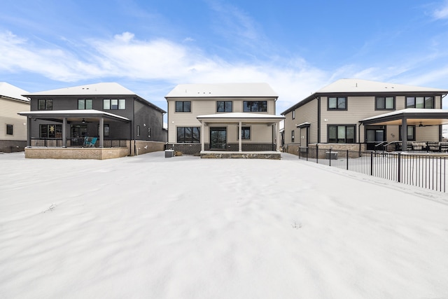 snow covered property with a porch