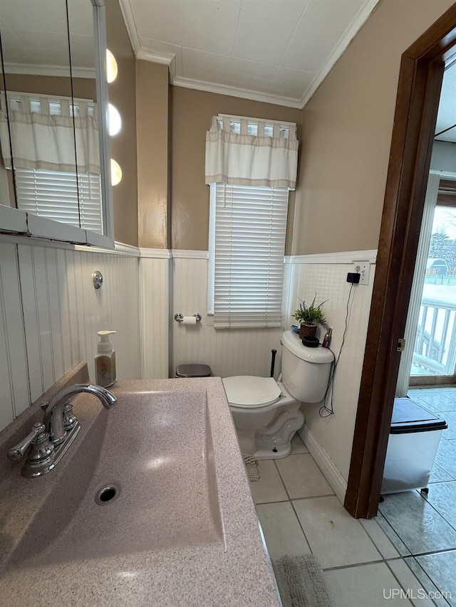 bathroom featuring ornamental molding, tile patterned flooring, and sink