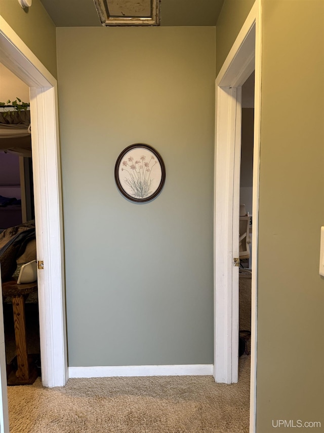 hallway featuring light carpet