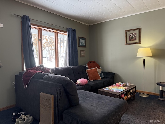 living room with crown molding and dark carpet