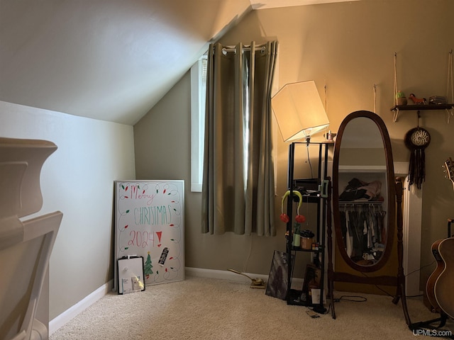 interior space with vaulted ceiling and light colored carpet