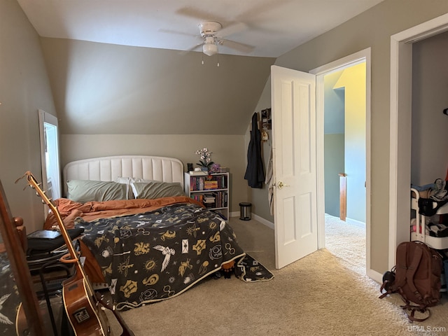 carpeted bedroom with vaulted ceiling and ceiling fan