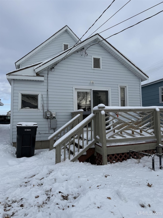 snow covered property featuring a deck