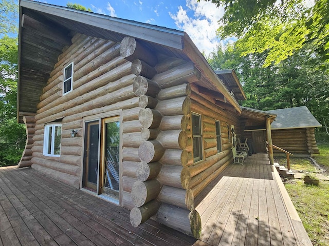 view of side of home featuring a wooden deck