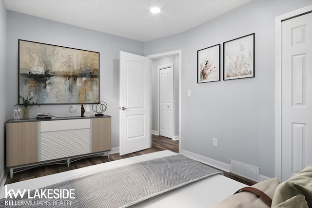 bedroom with dark hardwood / wood-style flooring