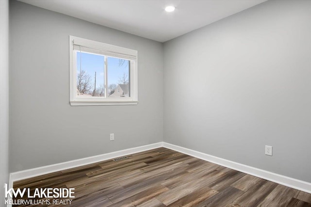 spare room featuring hardwood / wood-style floors