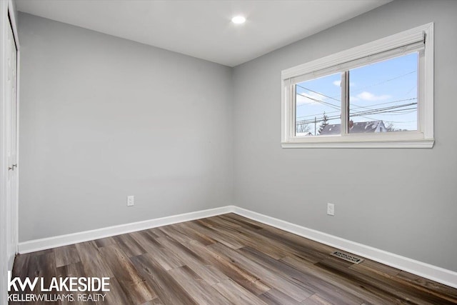 empty room with hardwood / wood-style floors