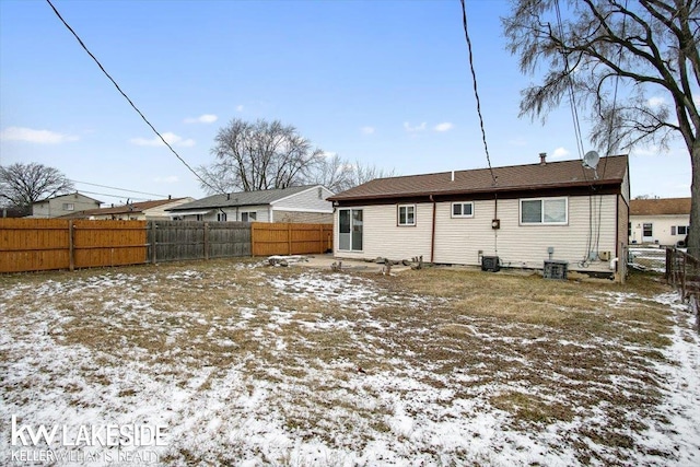 snow covered house featuring central air condition unit