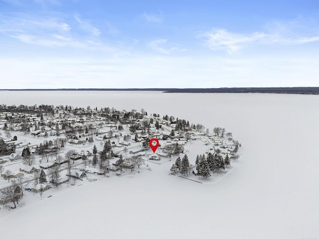 snowy aerial view featuring a water view