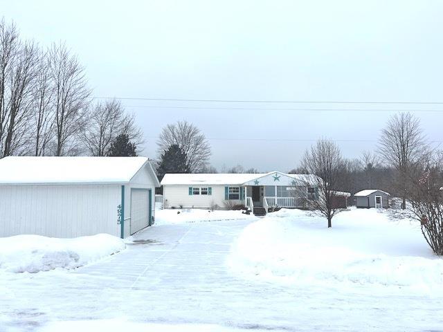 view of front of home with an outdoor structure and a garage