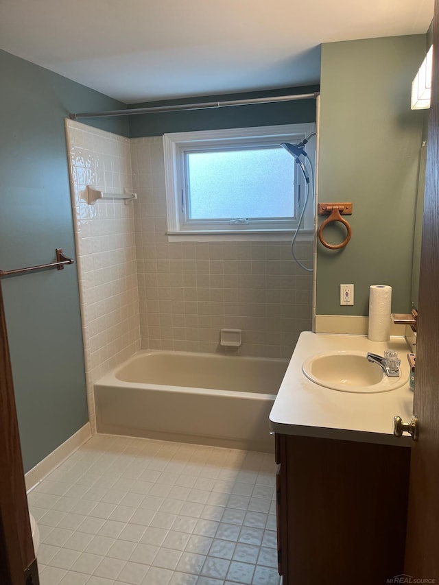 bathroom with tiled shower / bath combo, vanity, and tile patterned floors