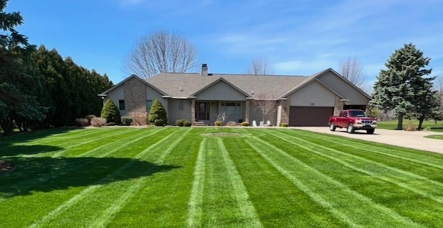 single story home with a garage and a front yard