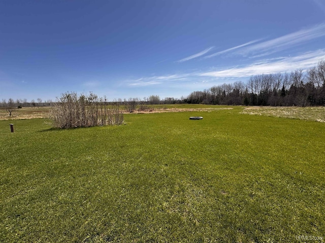 view of green lawn with a view of countryside