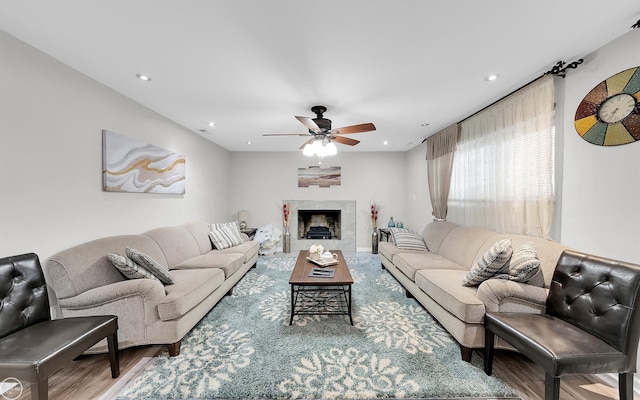 living room with ceiling fan and hardwood / wood-style floors