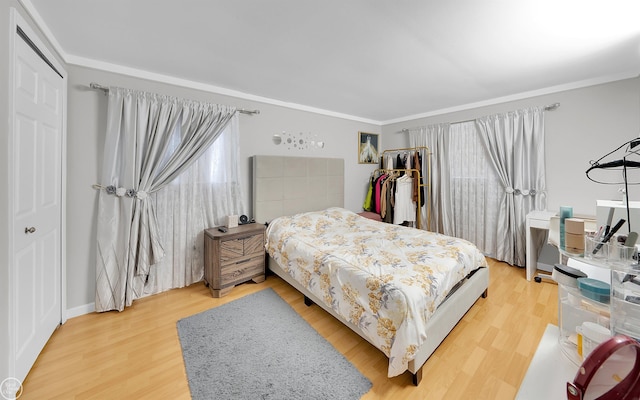 bedroom with crown molding and wood-type flooring