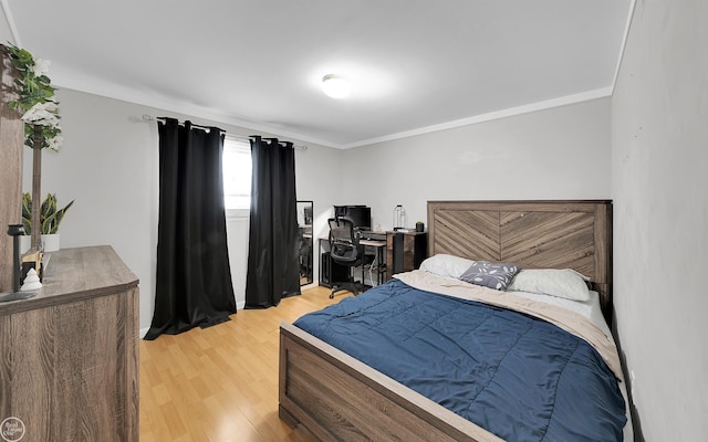 bedroom featuring crown molding and hardwood / wood-style flooring