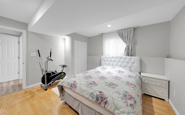 bedroom with wood-type flooring and a closet