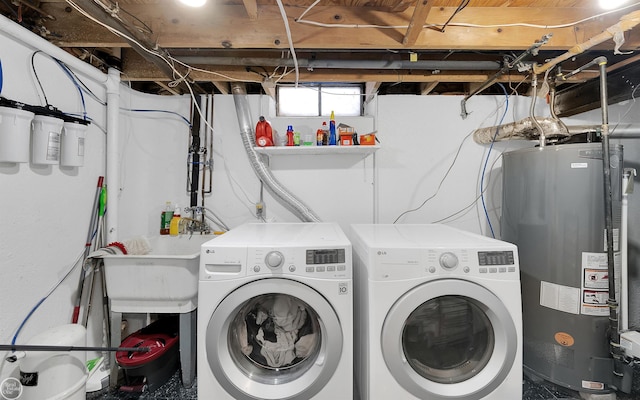 laundry area with washer and clothes dryer and gas water heater