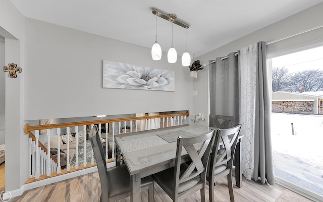 dining space with light hardwood / wood-style flooring