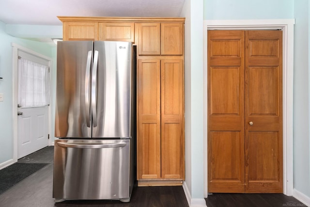 kitchen featuring stainless steel refrigerator and dark wood-type flooring