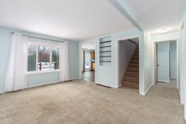 unfurnished living room with light carpet