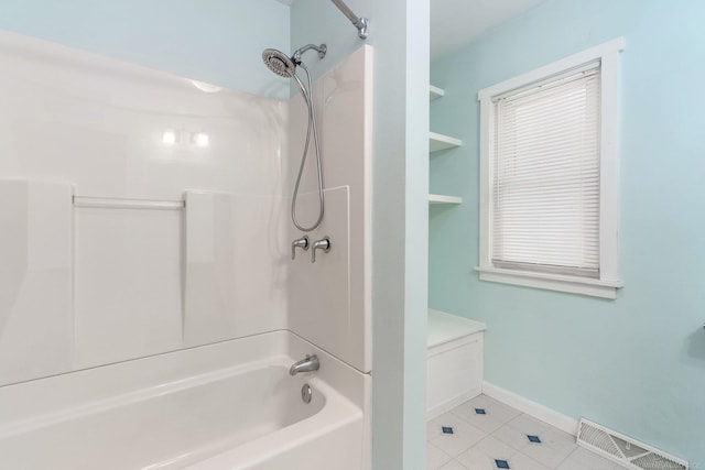 bathroom with tile patterned flooring and shower / bathtub combination