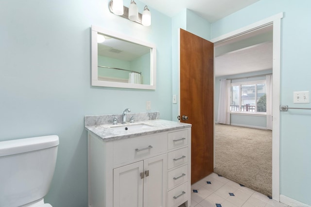 bathroom featuring vanity and toilet