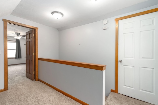 hallway with light colored carpet