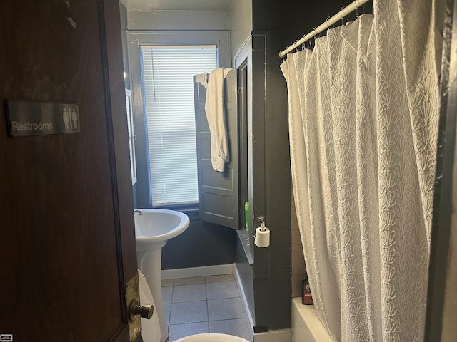 bathroom featuring shower / bath combination with curtain and tile patterned floors