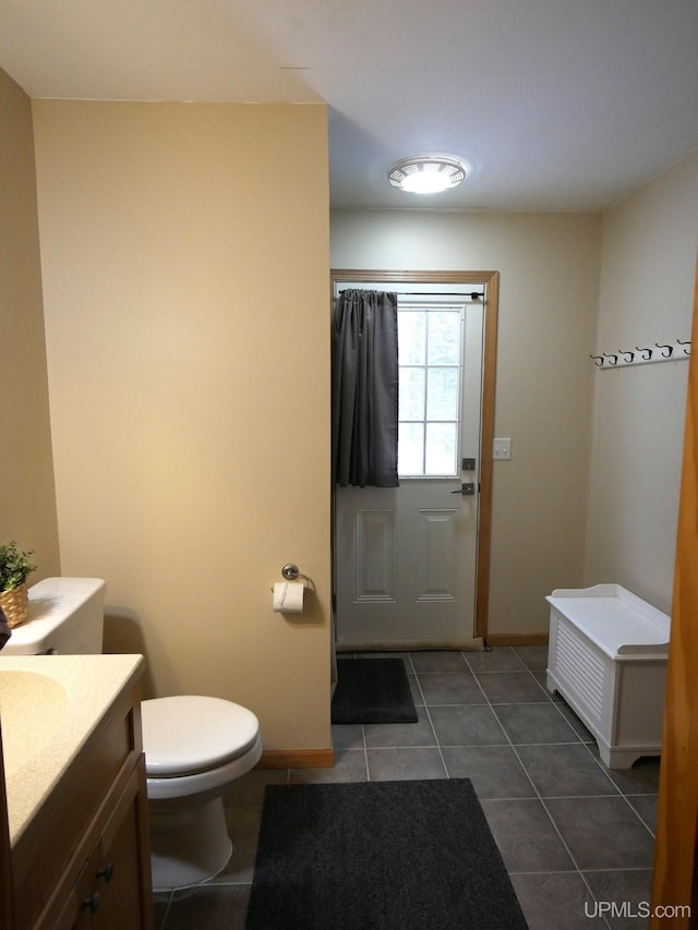 bathroom with vanity, toilet, and tile patterned flooring