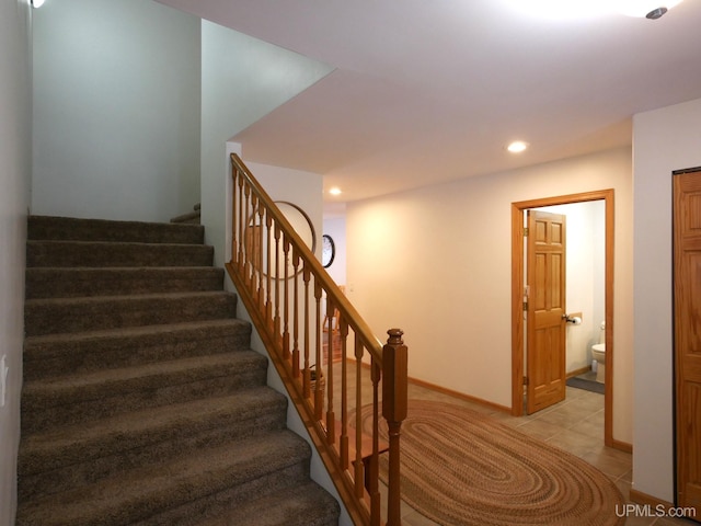 stairway featuring tile patterned floors