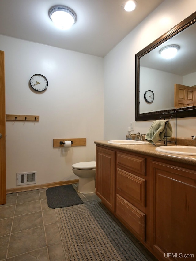 bathroom with vanity, tile patterned floors, and toilet