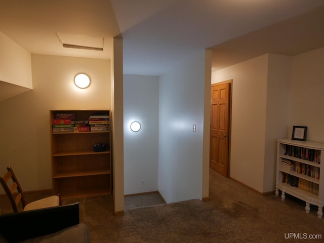 hallway with dark colored carpet