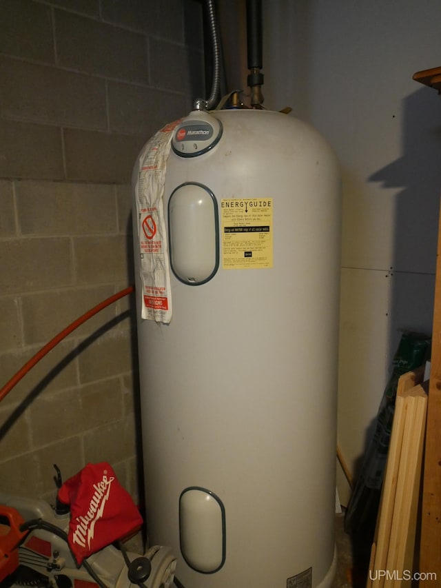 utility room featuring water heater