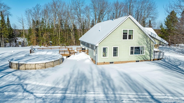 view of snow covered back of property