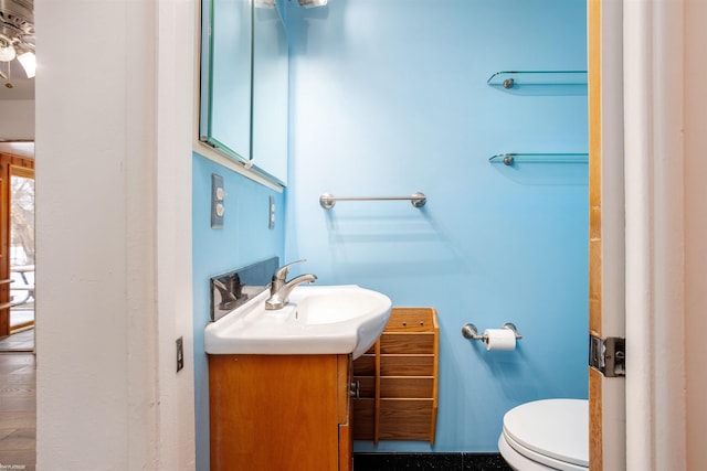 bathroom featuring vanity and toilet