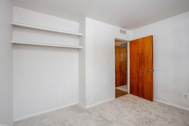 unfurnished bedroom with light carpet